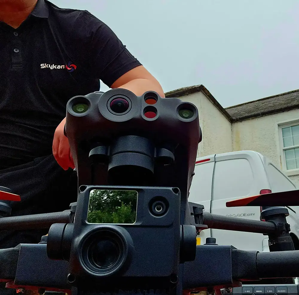 Professional UK drone survey pilot with DJI Matrice 350 RTK and multi-sensor payload for aerial surveying